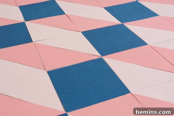 Blue tiles are interspersed between light and dark pink tiles.