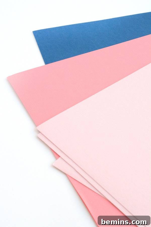 An array of napkin corners, one blue, one pink and one light pink.