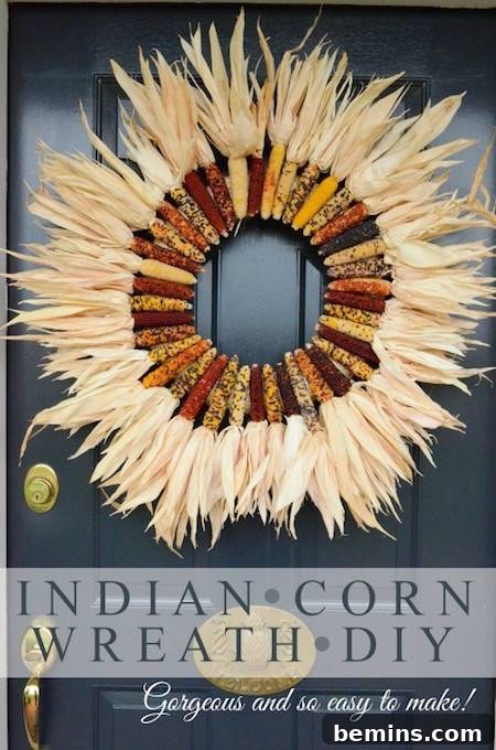 A vibrant wreath made of colorful Indian corn cobs, hanging on a front door as a welcoming fall decoration.