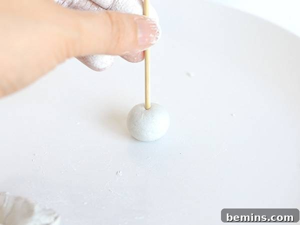Poking a hole in the clay ball
