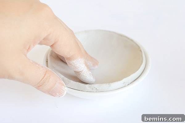Shaping the clay into a bowl