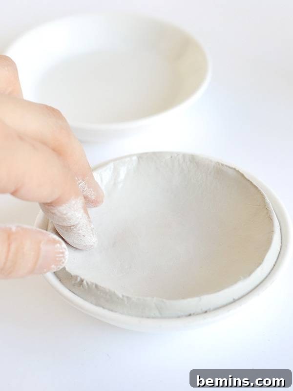 Smoothing the surface of the clay