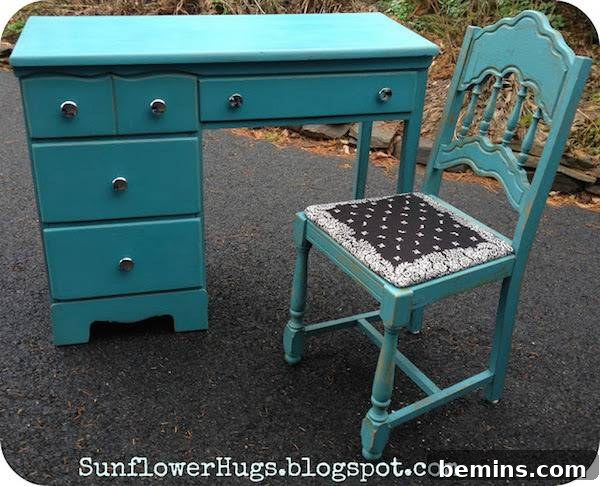 A turquoise desk & chair sit outside.