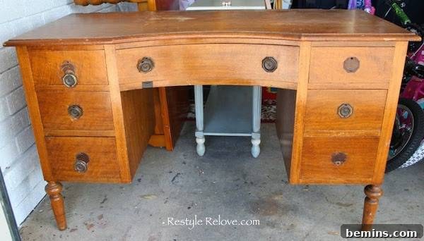 Wooden desk with multiple drawers.