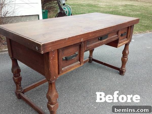 A brown beat up desk with the word, before, overlaying the pavement.
