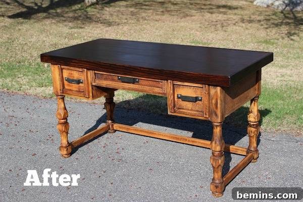 An after picture of a wooden desk is outside.