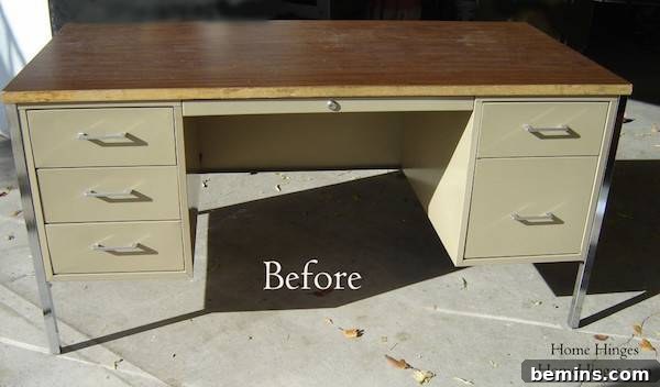 An old metal office desk with a wooden top, sitting outside on concrete ready to be made over.