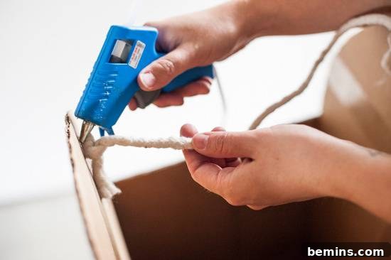 Attaching rope shoulder straps to the cardboard popsicle