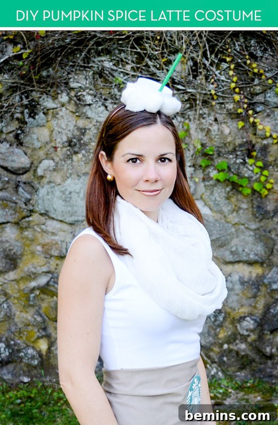 A woman showcasing her DIY Pumpkin Spice Latte costume, featuring a white dress and PSL-themed accessories.