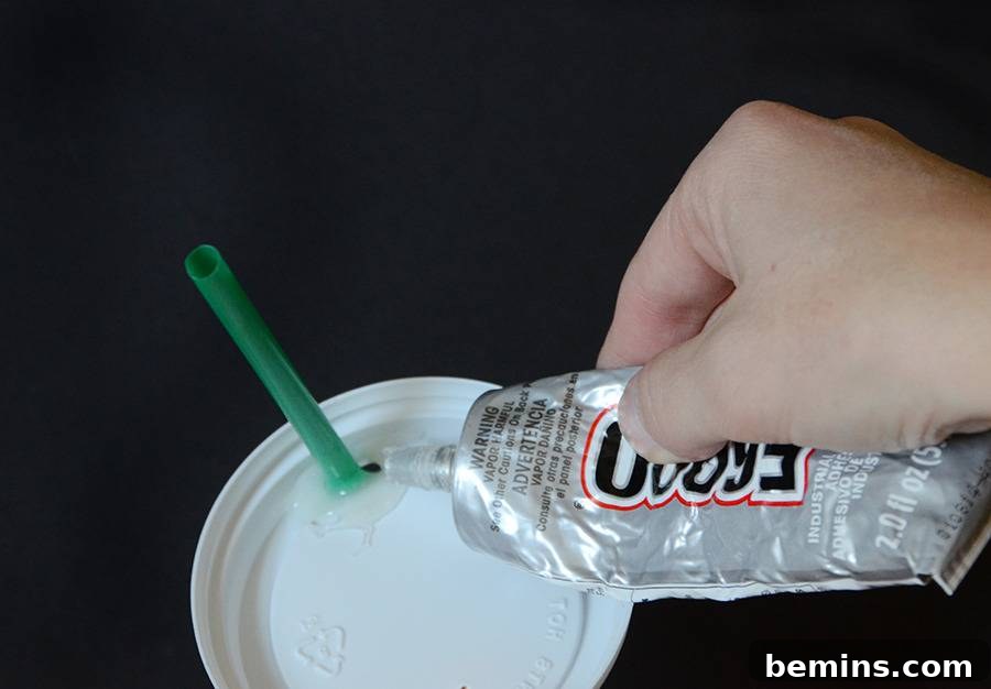 Close-up of the coffee cup top with a straw inserted, ready for the whipped cream creation.