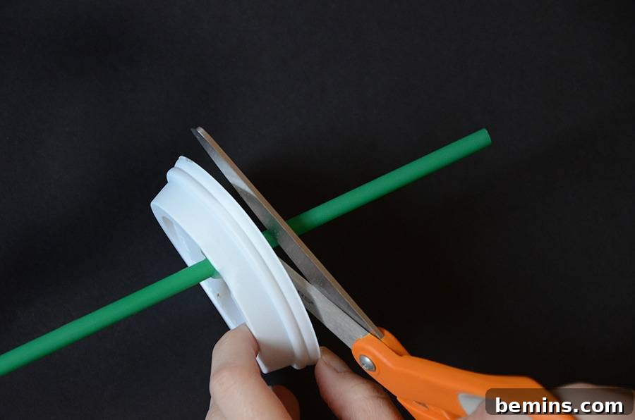 The coffee cup top with the excess straw trimmed, ready for the cotton ball whipped cream.