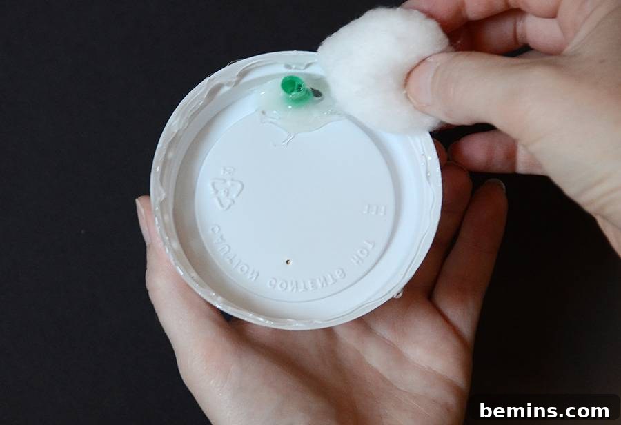 The coffee cup top adorned with cotton balls, creating a fluffy whipped cream effect.