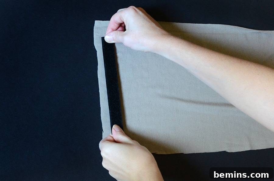 The light brown fabric sleeve with the Starbucks logo glued in the center, ready to be worn around the waist.