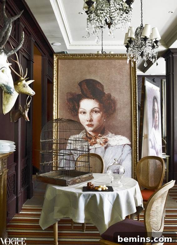 Oversized portraits by Jean-Baptiste-Camille Corot, birdcage, and antique trophy heads create a unique and artistic atmosphere.