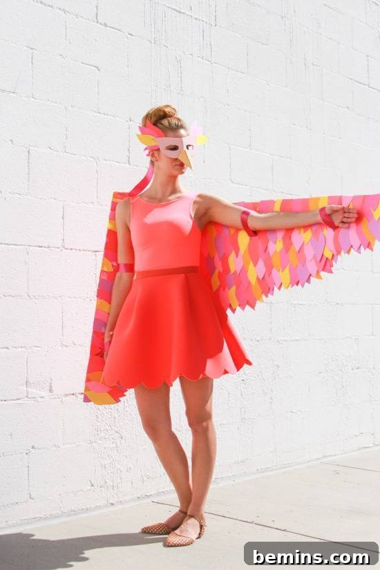 Craft Your Own Bird Costume: A Step-by-Step Guide 12 A woman in a red bird costume with her arm held out.