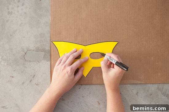 Craft Your Own Bird Costume: A Step-by-Step Guide 5 A person traces the outline of a mask on cardboard.