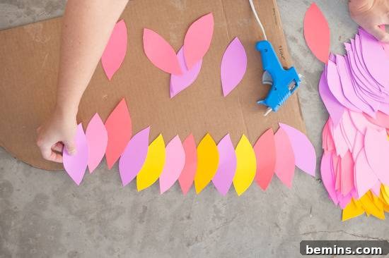 Craft Your Own Bird Costume: A Step-by-Step Guide 8 A person is using cutout papers to make designs.