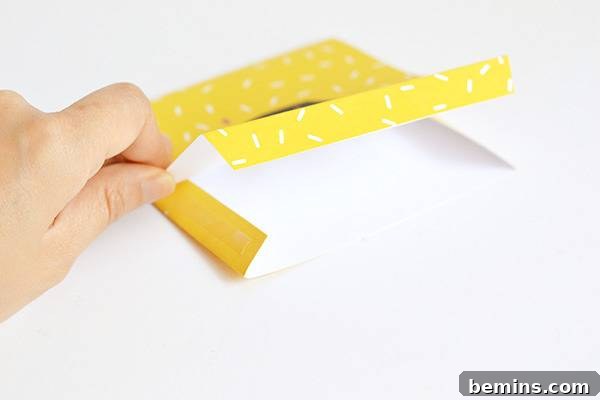 Sticking the Halloween fang treat bag together