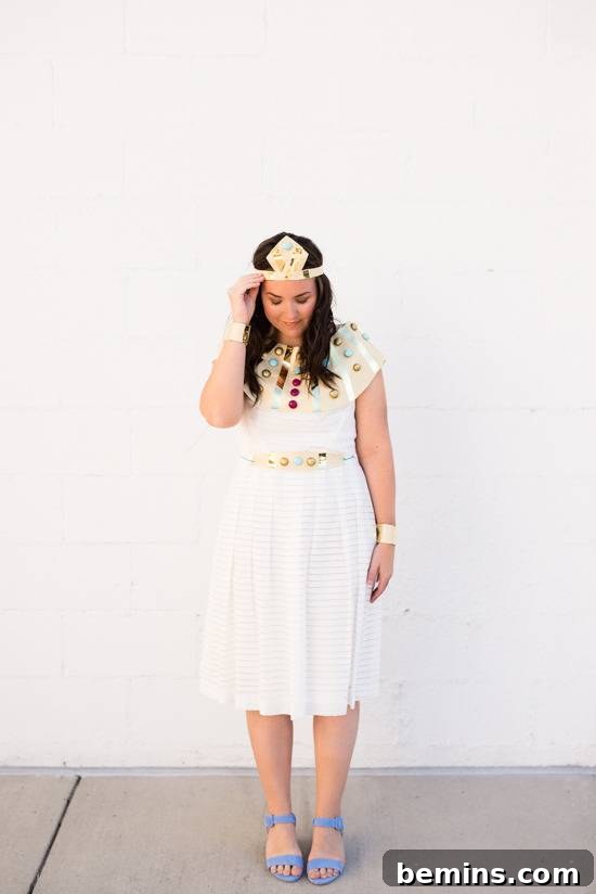 A lady in a white summer dress and purple shoes looks down at her shoes.