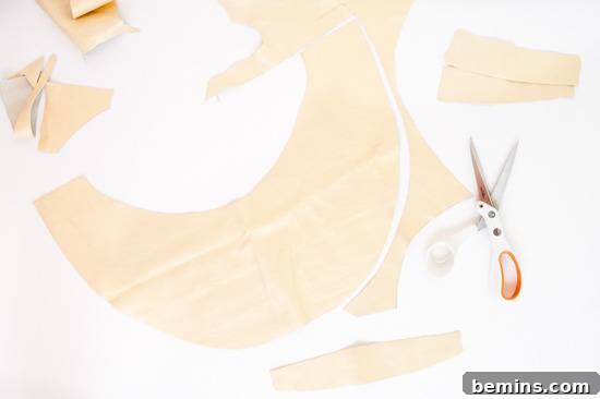 Beige colored paper has scissors on it.