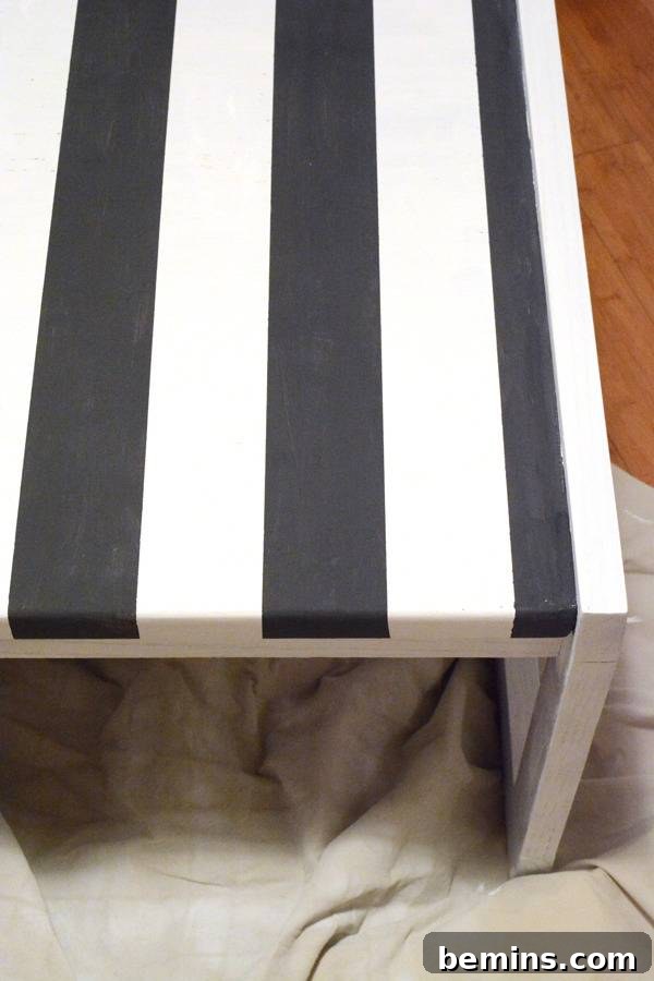 A blue and white striped table on a blanket.