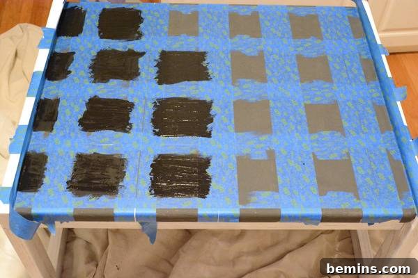 A blue and black grid is made by tape on a surface.