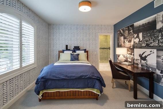 A bedroom with a wooden bed, blue and white bedding, and an accent wall featuring a collage of black and white photos, creating a sophisticated and adaptable space.