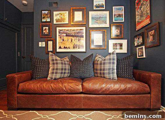 A living room with a brown couch, designer pillows, and different wall painting frames, illustrating how dark walls can enhance colorful sports photos.