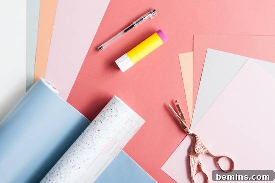 Craft Quick Wall Art: A 30-Minute DIY Project 4 Construction paper piled up with scissors and a glue stick resting on top of them.