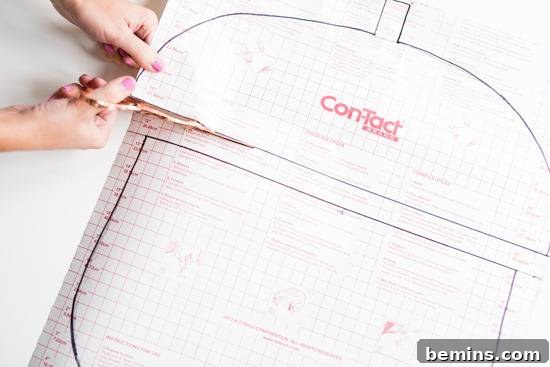 Craft Quick Wall Art: A 30-Minute DIY Project 6 A person is using scissors to cut the contact paper.