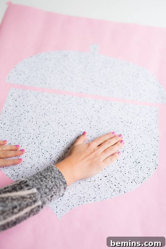 Craft Quick Wall Art: A 30-Minute DIY Project 9 A hand on a pink and silver craft item spread out