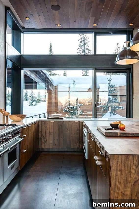 Visual Delight: 10 Modern Yet Cozy Cabins Perfect for a Woodland Escape 3 Kitchen with wooden counters, wooden ceiling, and large windows showcasing a natural view.
