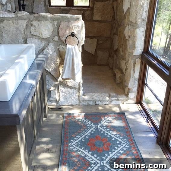 Visual Delight: 10 Modern Yet Cozy Cabins Perfect for a Woodland Escape 6 Bathroom interior with a patterned rug and rustic details, blending modern and rustic elements.