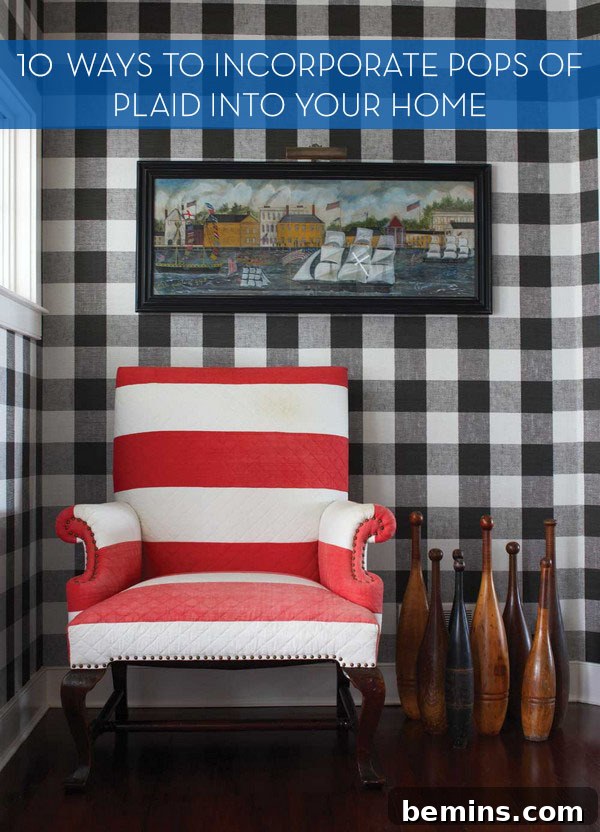 Plaid Power: 10 Rooms Where Tartan Truly Shines 2 A red and white striped chair stands out against a black and white plaid background, showcasing a bold contrast.