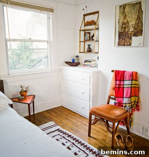 Plaid Power: 10 Rooms Where Tartan Truly Shines 8 A well-lit white room featuring an orange chair, showcasing a minimalist and stylish interior design.