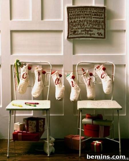 Christmas stockings are hanging as a garland between chairs.