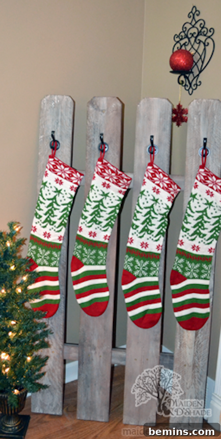 Several Christmas stockings hang from boards.