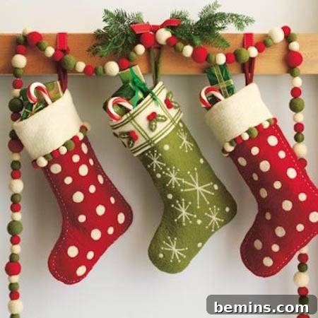 Red and green Christmas stockings hanging with candy and goodies.