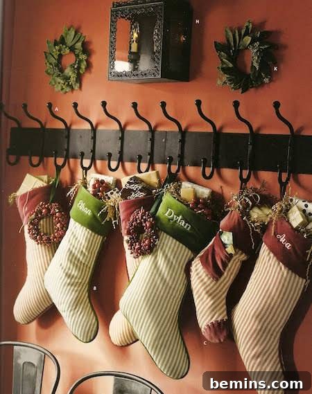 Christmas stockings hanging on a wall from a coat rack.