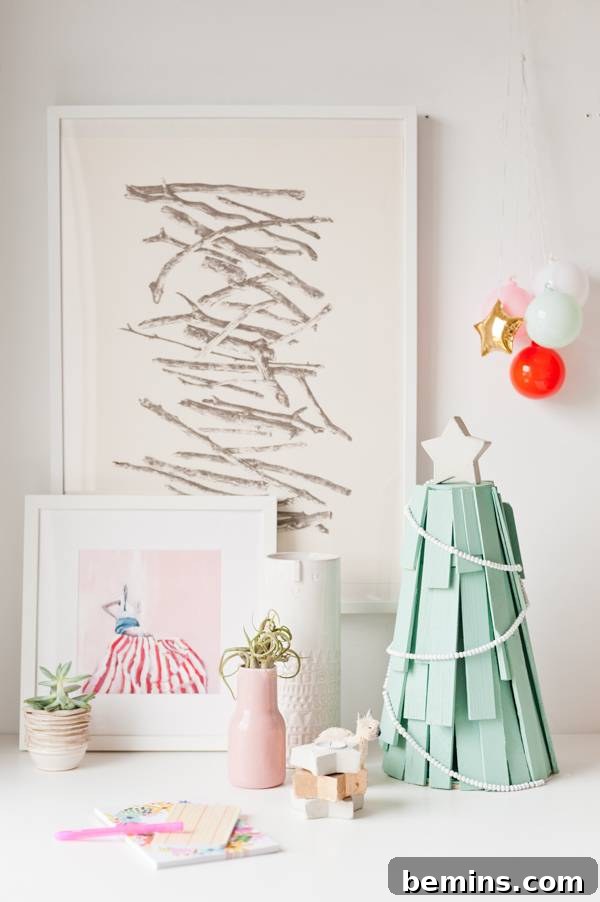 A scribbled drawing on the wall complements a green Christmas tree in the room.