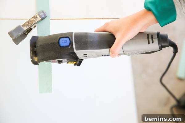 A person is using a power tool on a surface.