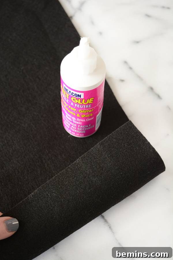 Black felt and glue, showing the materials used to create the dowel sleeve.
