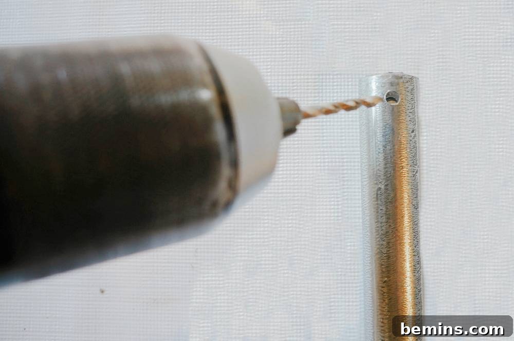 Drilling holes in the pipes for Christmas Bells