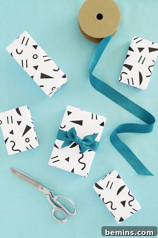 Small, stylish black and white gift-wrapped boxes featuring a modern geometric pattern, elegantly tied with vibrant blue ribbons, creating a chic and contemporary gift presentation.