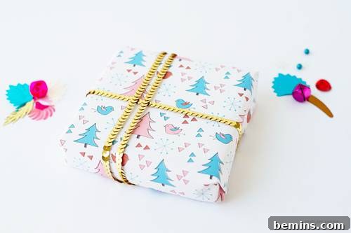 A tastefully printed white gift wrap adorned with simple Christmas trees, elegantly tied with a shimmering gold-colored chain, creating a festive and modern presentation.