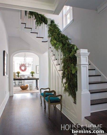 An elegant banister decorated with simple, understated elegance for a Christmas function.