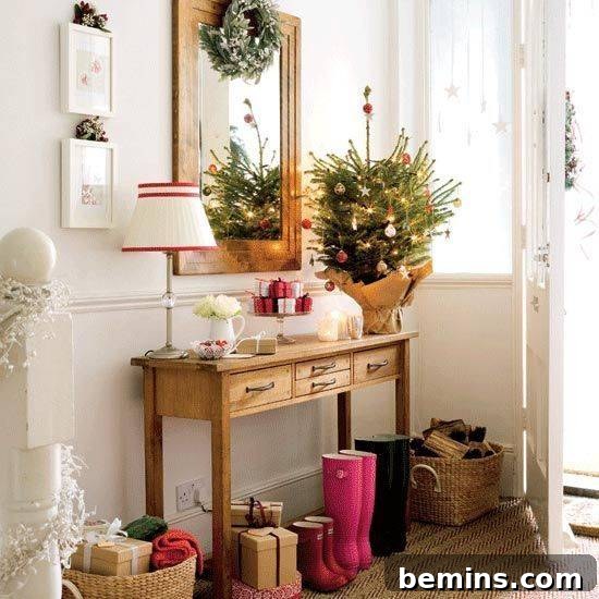A welcoming entryway with neatly lined boots, a decorative side table, and a festive wreath above a mirror.