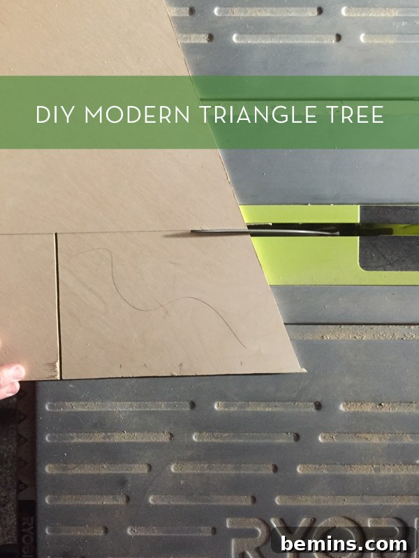 Modern triangle tree in green color, a stylish DIY Christmas decoration.