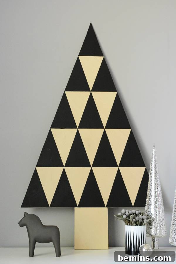 Triangle shaped wall art with Christmas decorations in background