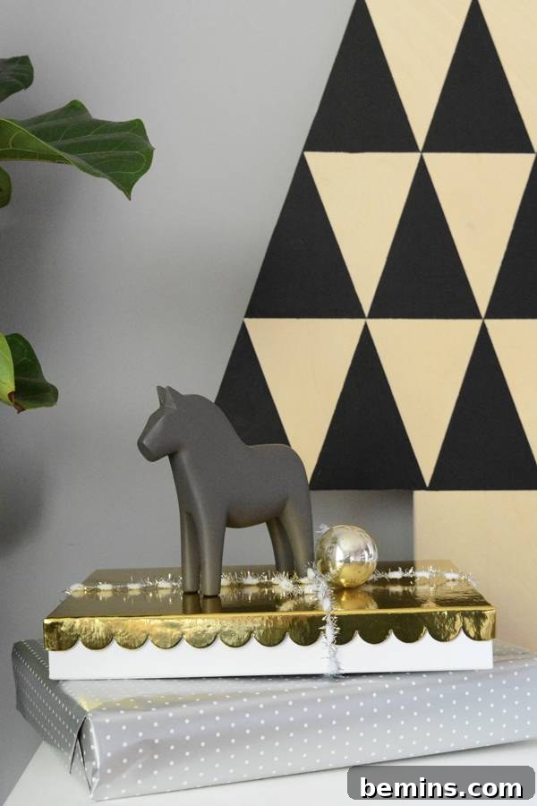 A gift box wrapped in golden paper having a horse toy at the top, a scene creating christmas ambience.